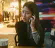 woman talking on phone outdoor in front of store