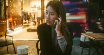 woman talking on phone outdoor in front of store