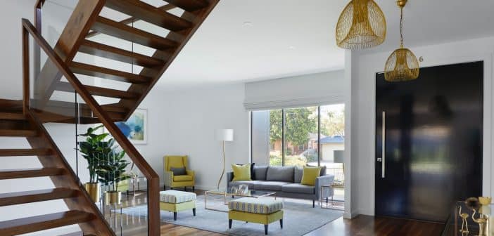 brown wooden spiral staircase near gray couch