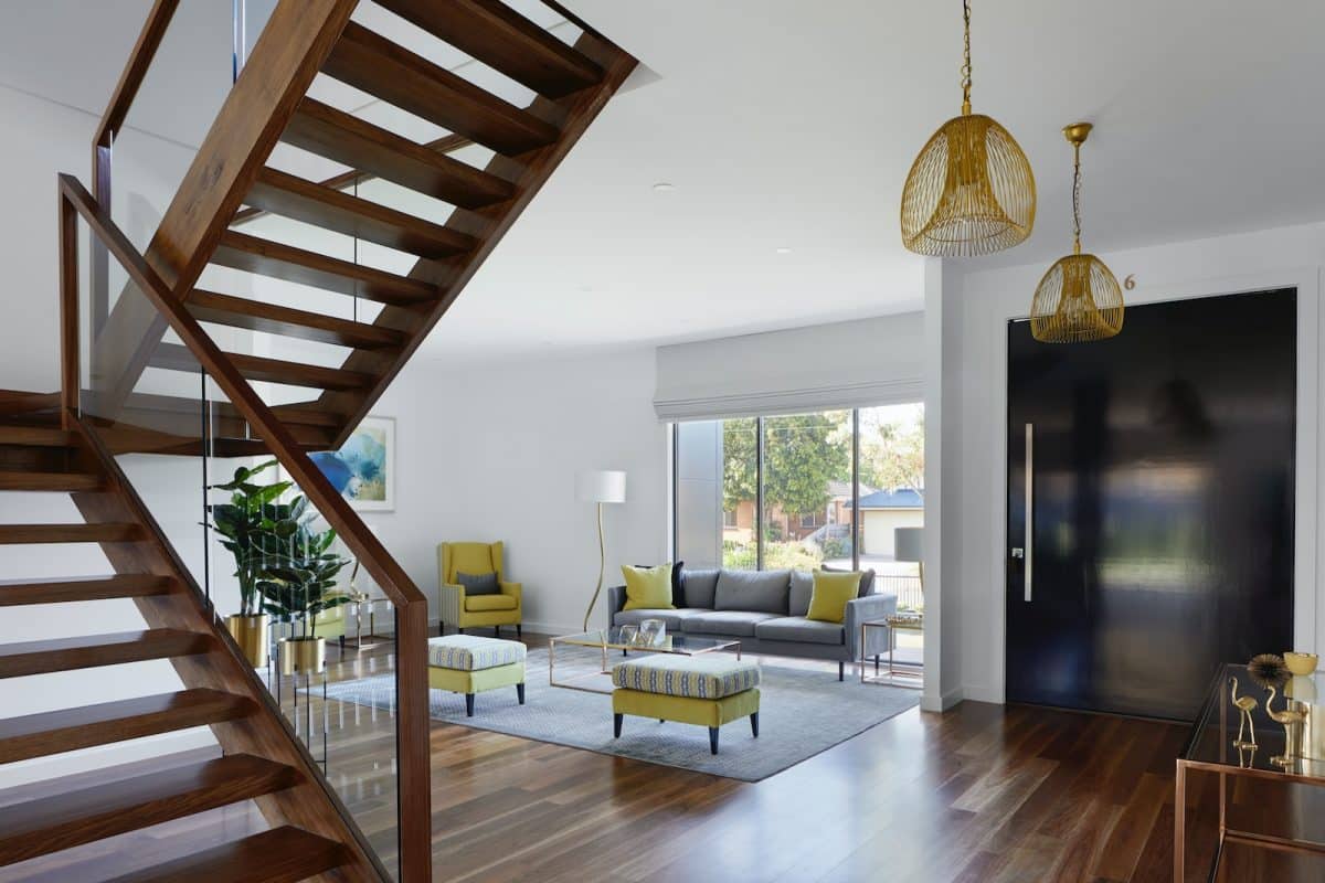 brown wooden spiral staircase near gray couch