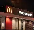a mcdonald's restaurant is lit up at night