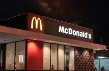 a mcdonald's restaurant is lit up at night